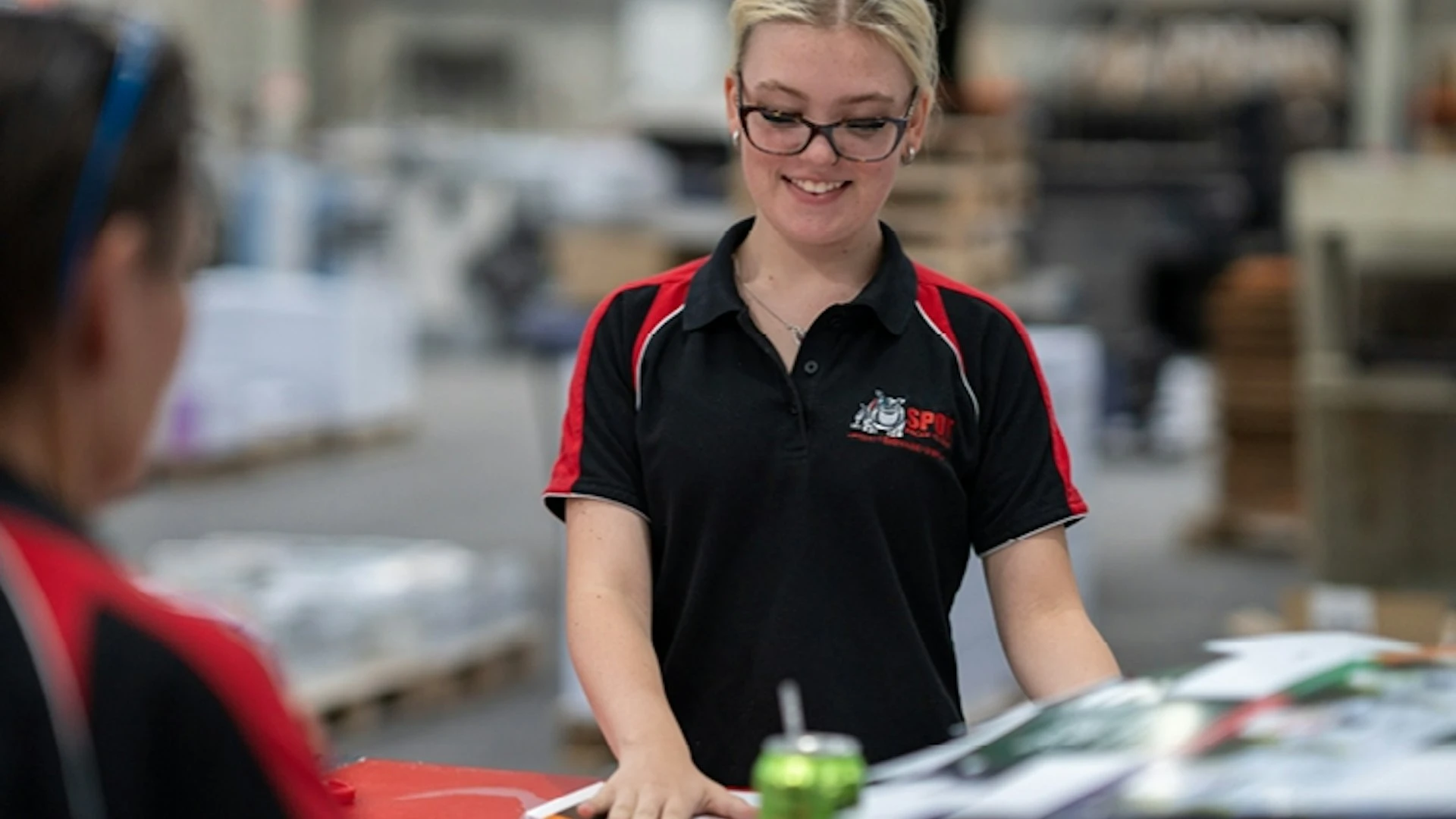 smiling-young-female-factory-worker-in-warehouse.webp