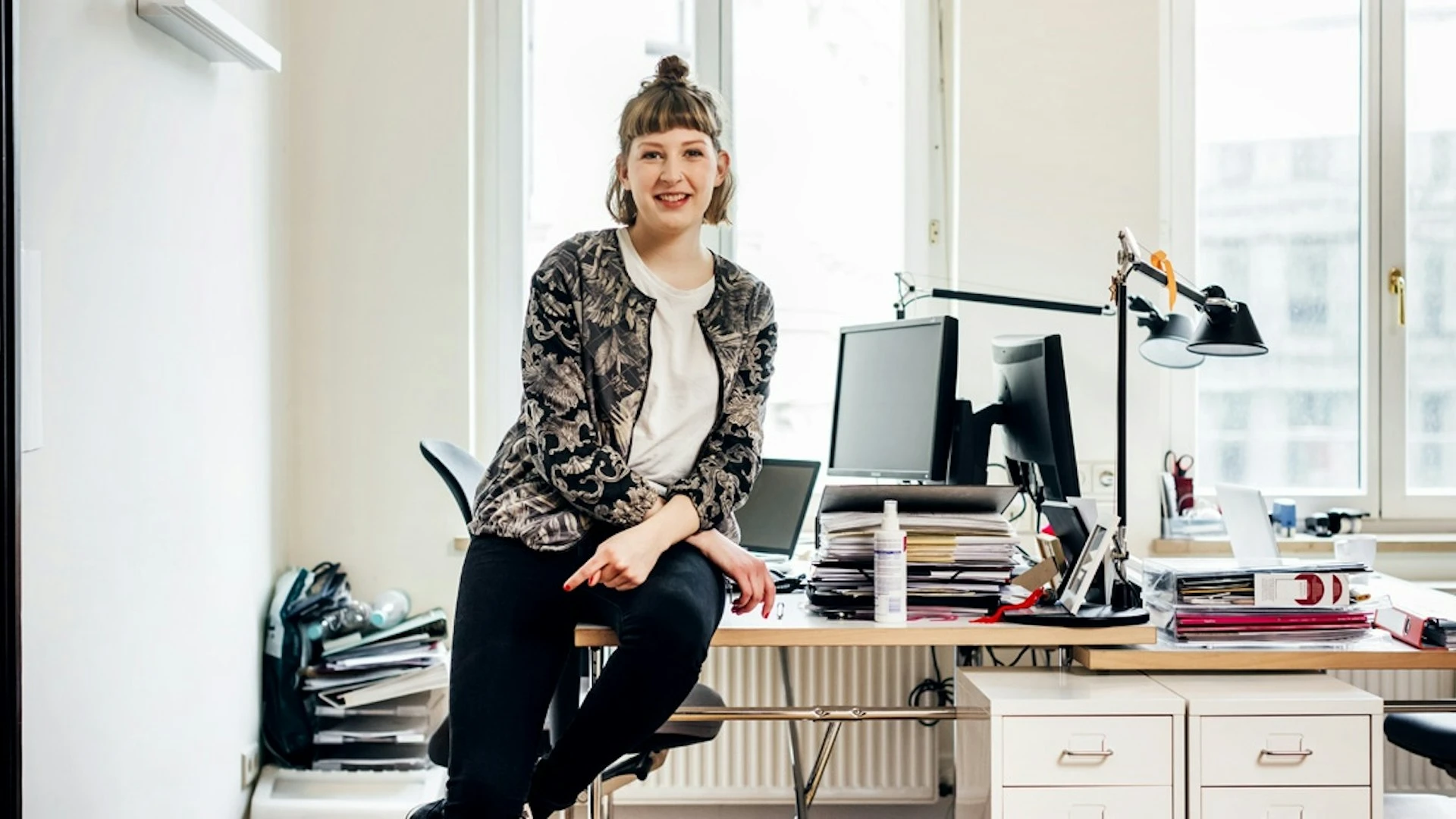 Young woman sitting on her desk